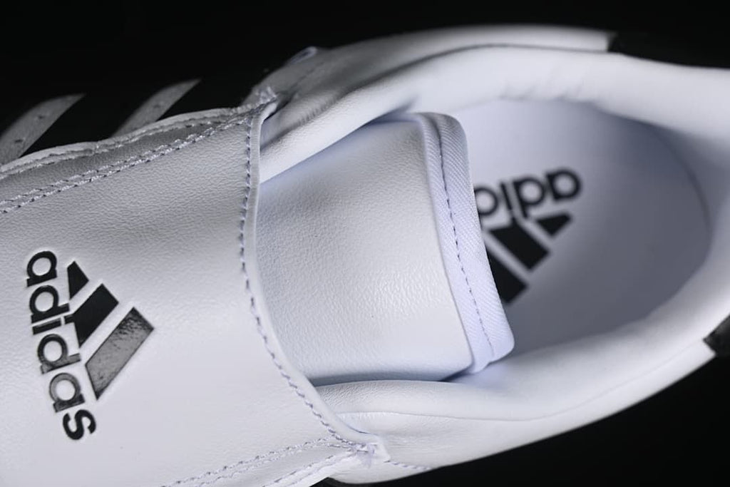 Top view of the shoe opening, tongue, and insole branding.