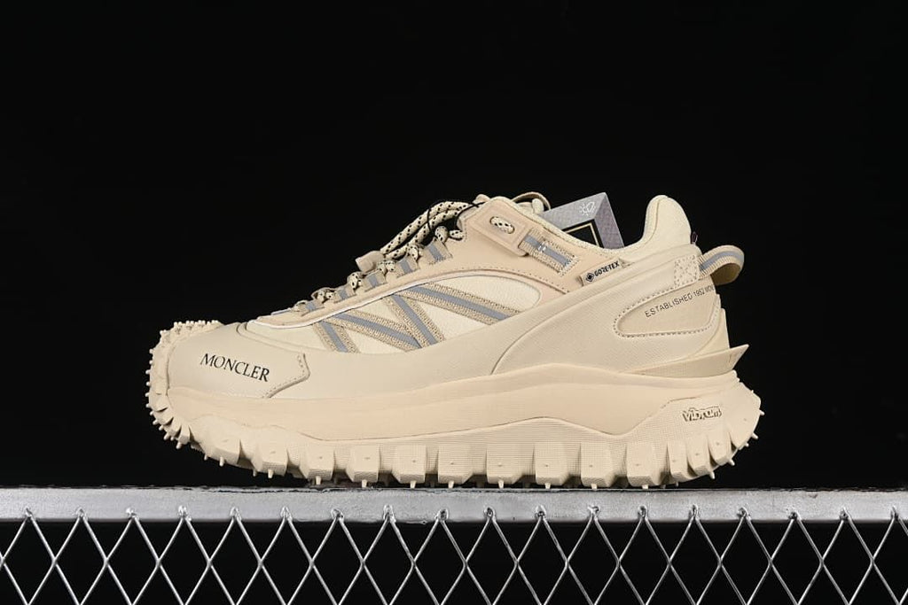 Side view of a beige Moncler Trailgrip GTX sneaker with a rugged outsole.