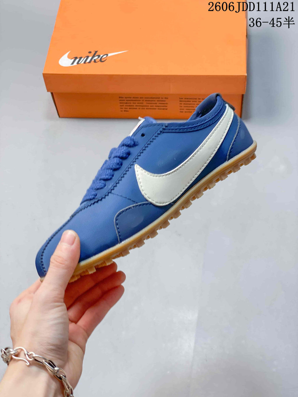 Side profile of the blue low-top sneaker with a white side accent and gum-colored outsole