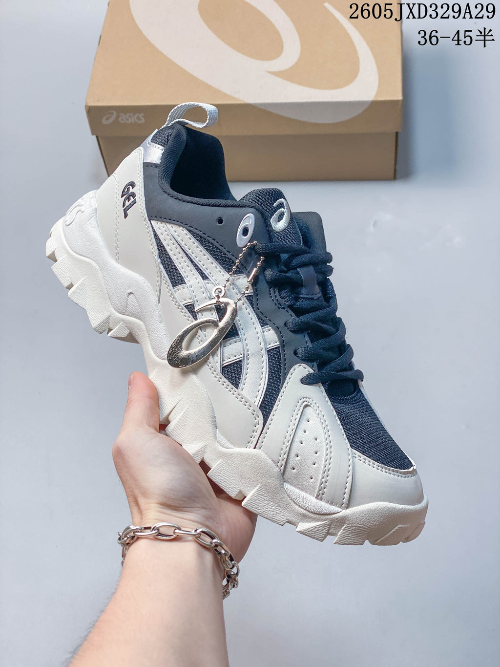 Side view of a navy and white Onitsuka Tiger sneaker with contrasting stripes and a chunky white outsole.