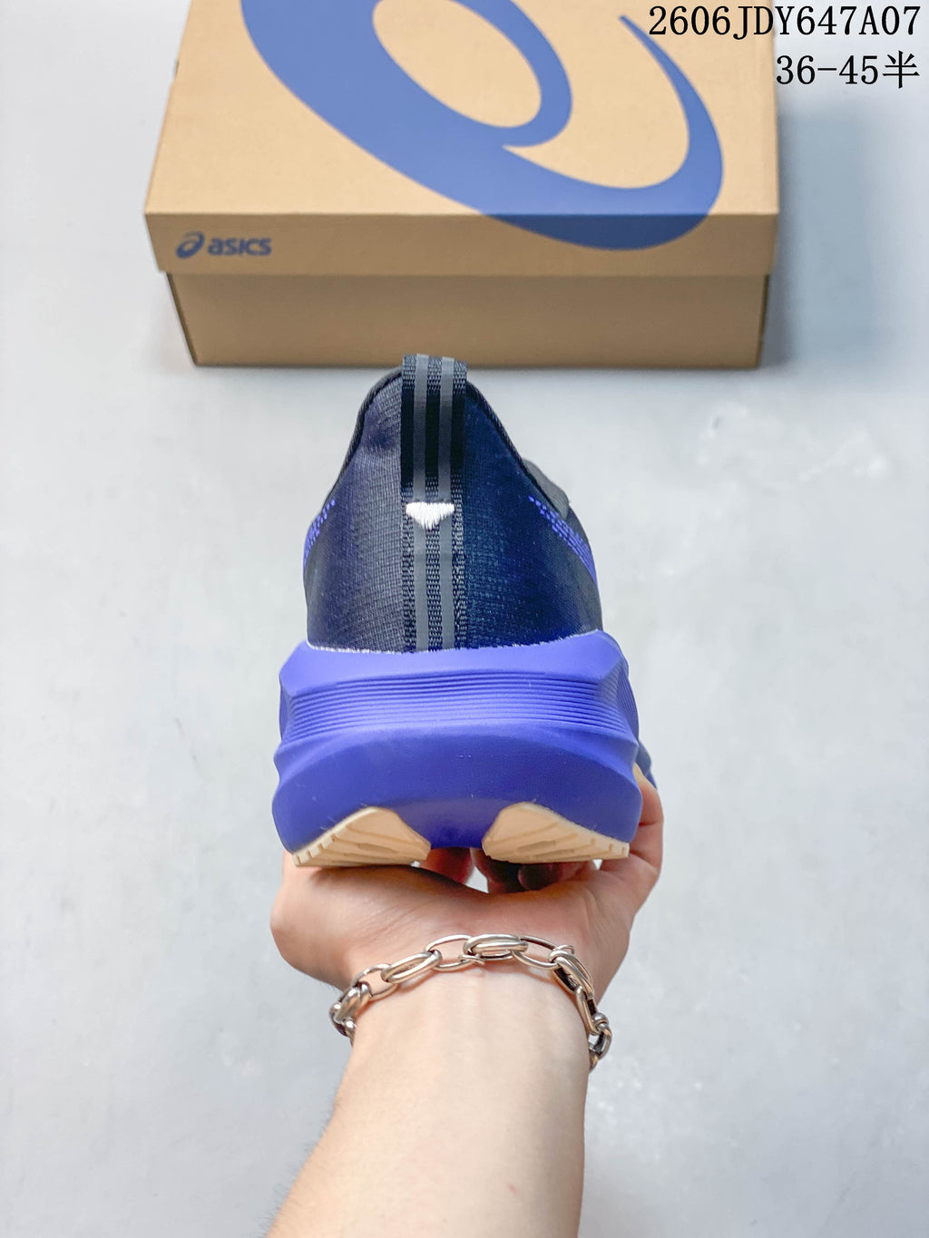 Rear view of a running shoe with a purple heel midsole
