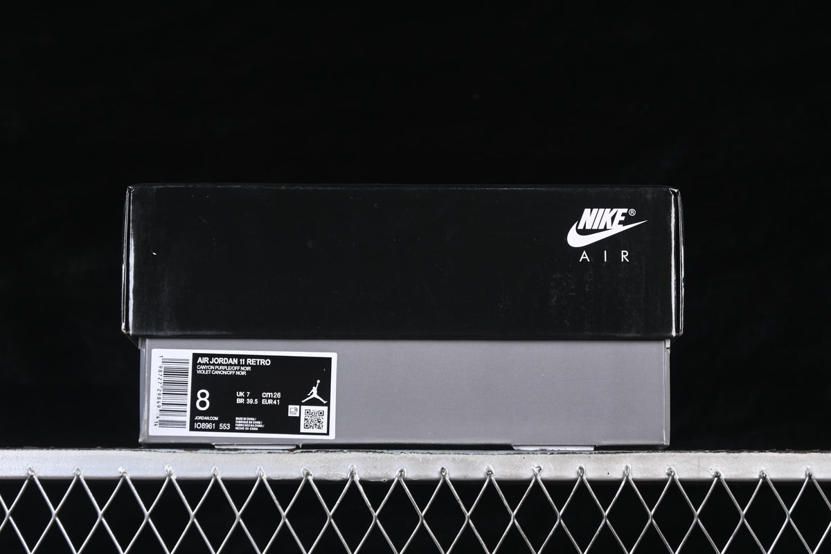 Shoe box label identifying Air Jordan 11 Retro, Canyon Purple, and style code IO8961-553; sample size shown.