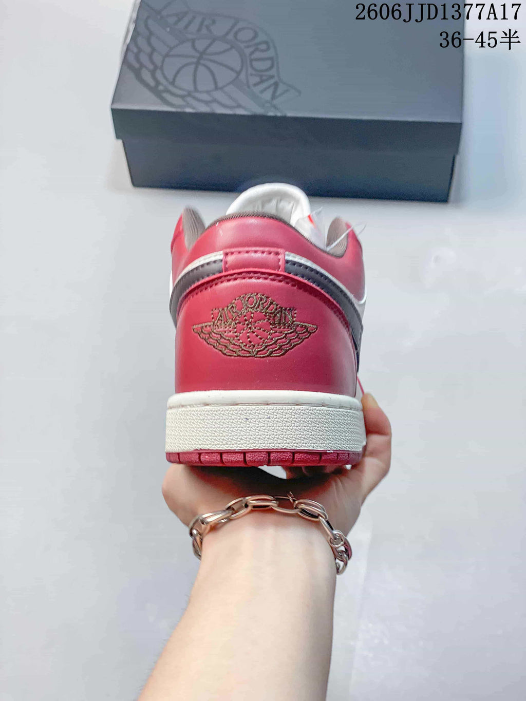 Rear view showing the burgundy heel and embroidered logo
