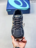 Front view of a dark navy and black ASICS Gel-Kahana 8 FL sneaker with gold-toned detailing and a lace-up upper.