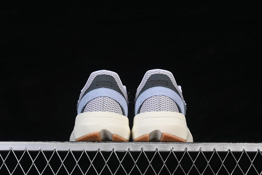 Rear view of the light blue and gray adidas Lightblaze sneakers