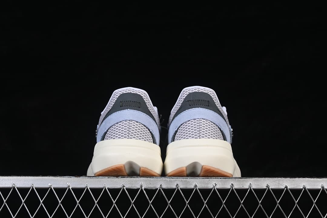 Rear view of the light blue and gray adidas Lightblaze sneakers