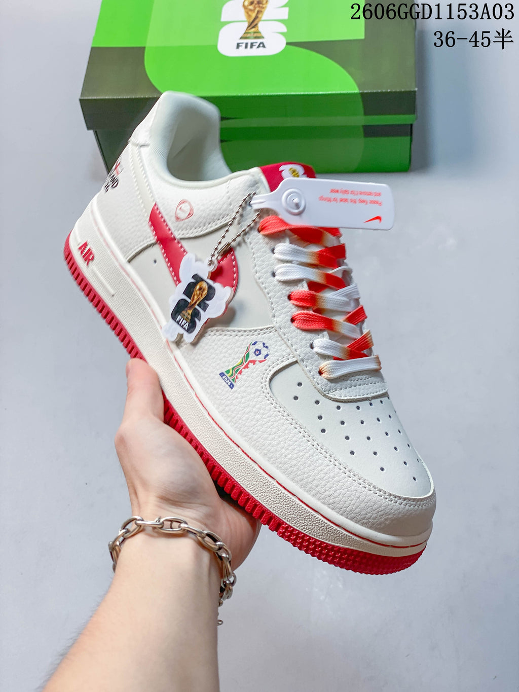 Angled view of the white and red sneaker with decorative tags and side details.