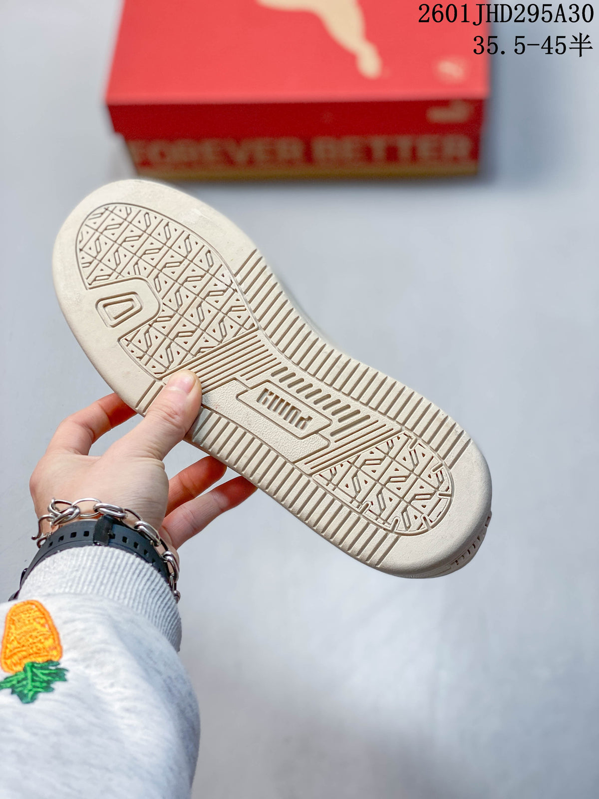 Close-up of the patterned outsole on a cream Puma sneaker