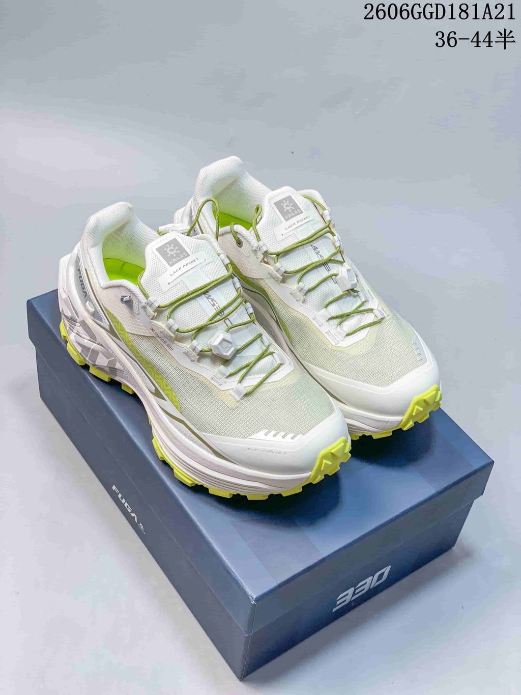 Pair of white Kailas FUGA EX BOA trail running shoes with lime accents and dial closures