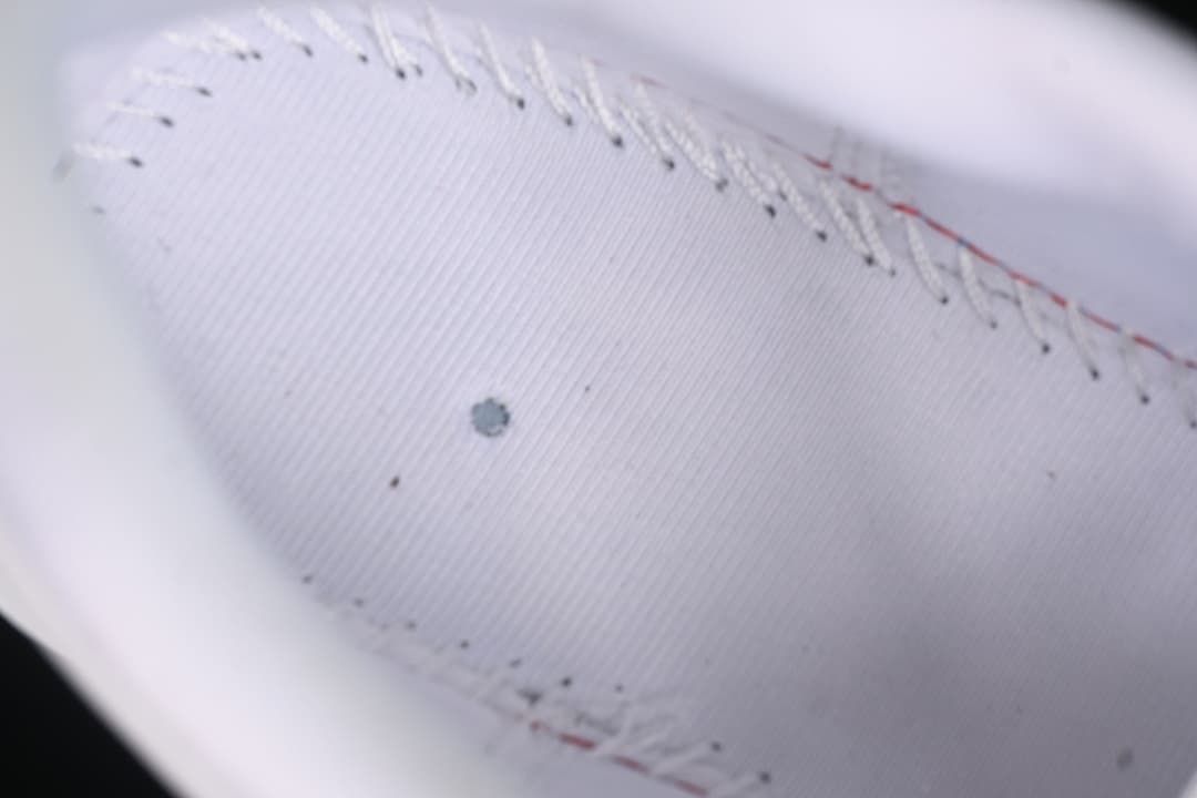 Close-up of the shoe's white interior stitching and lining.