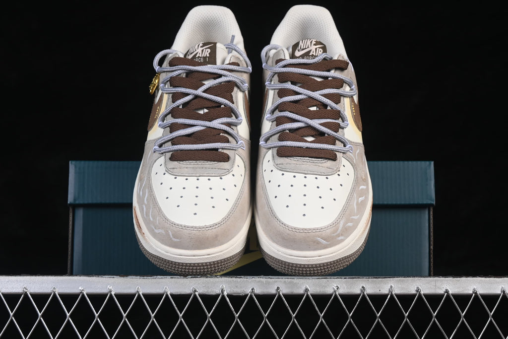 Front view of cream and taupe low-top sneakers with brown and lavender laces and illustrated accents