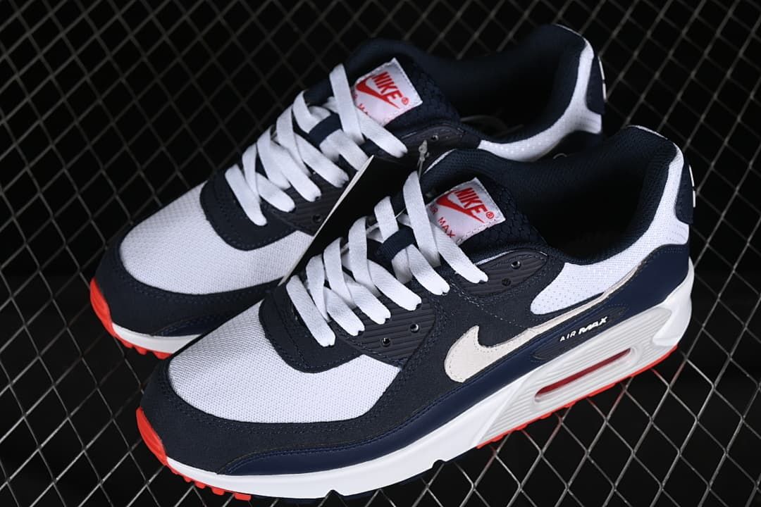 Pair of navy, white, and red Nike Air Max 90 sneakers