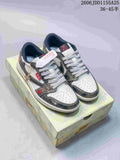 Pair of white and metallic gray Jordan low-top sneakers on a patterned box