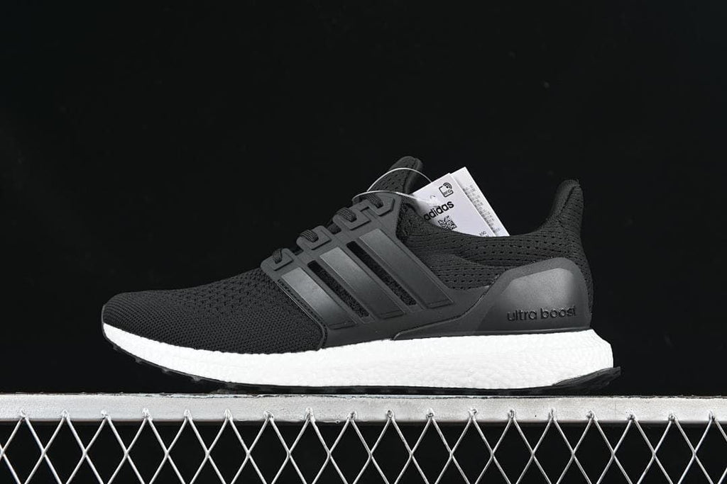 Side view of black adidas UltraBoost 1.0 sneakers with a white midsole.