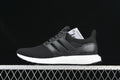 Side view of black adidas UltraBoost 1.0 sneakers with a white midsole.