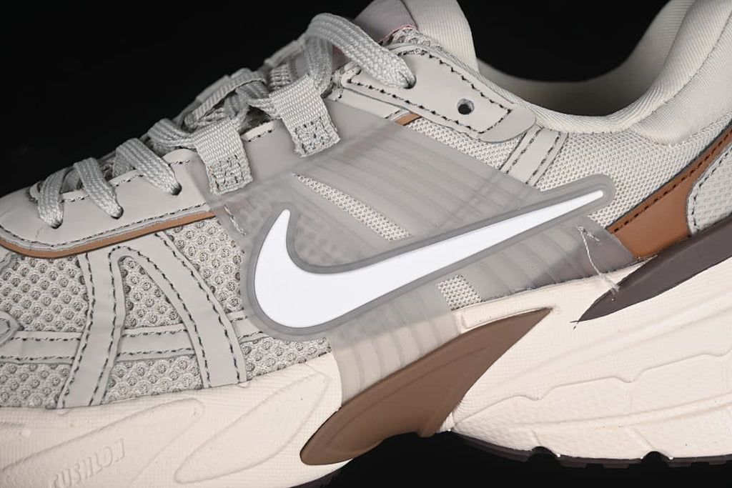 Close-up of the side Swoosh, layered panels and brown accent