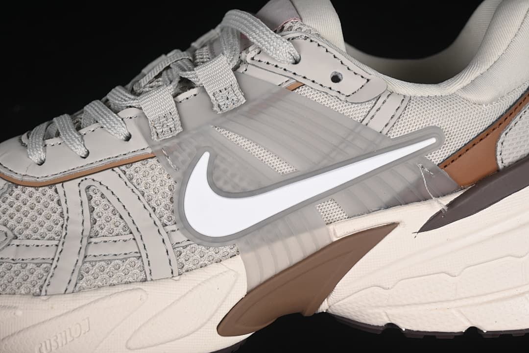 Close-up of the side Swoosh, layered panels and brown accent