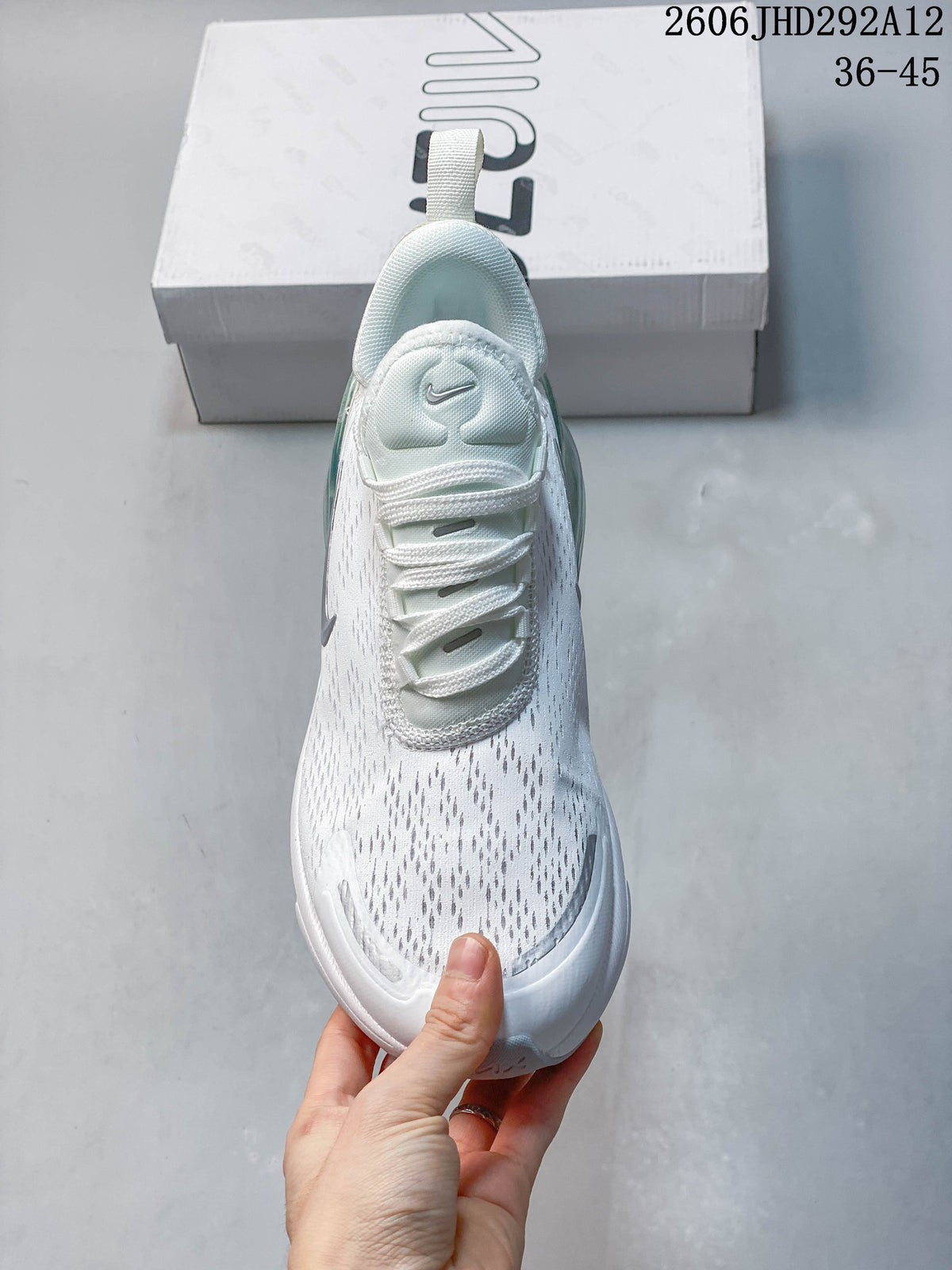 Top view of the white sneaker showing its laces and patterned upper.