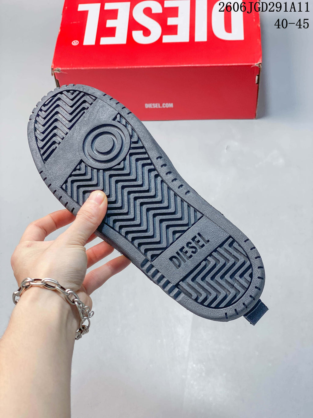 Close-up of the patterned outsole on a dark gray sneaker