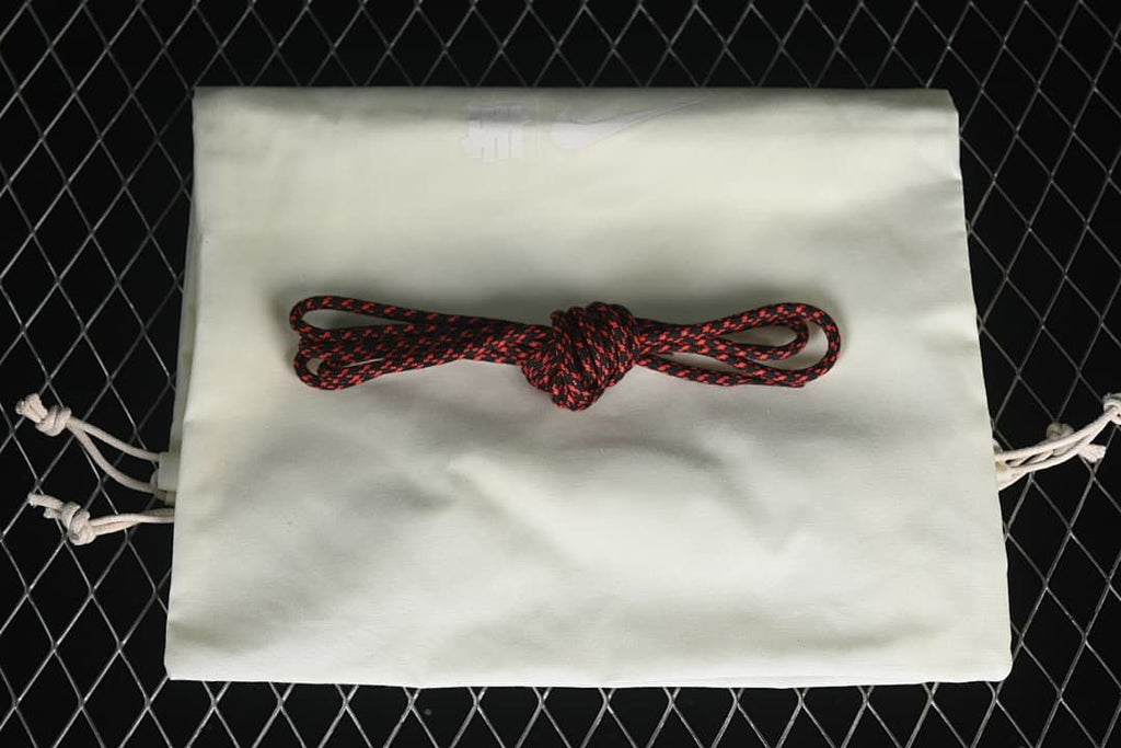Black-and-red spare laces displayed on a white drawstring bag