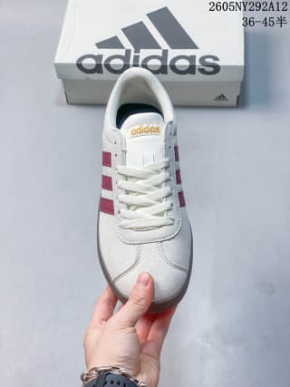 Top view of the sneaker showing the lace-up vamp, tongue, and burgundy side stripes.
