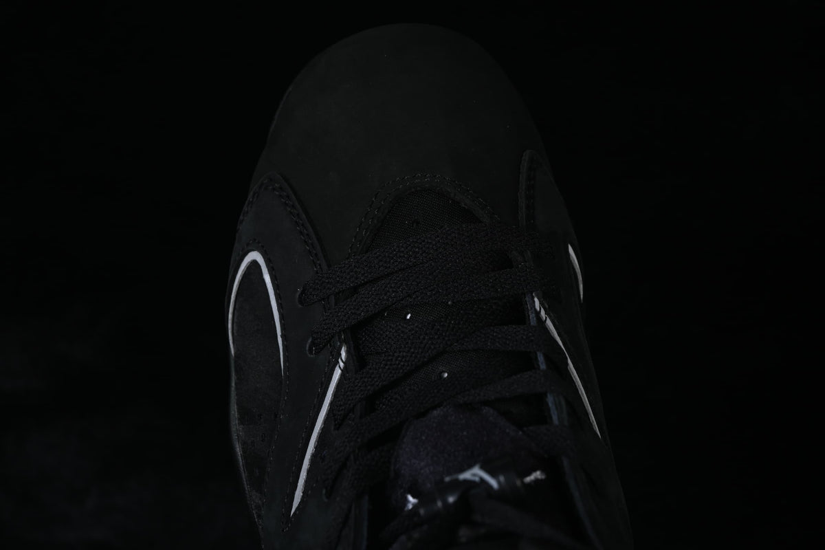 Top-down close-up of the black laces and perforated sneaker panels.