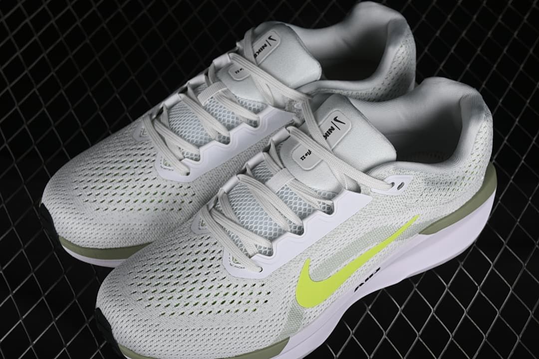 Pair of white and light gray Nike Winflo 11 shoes with volt accents.