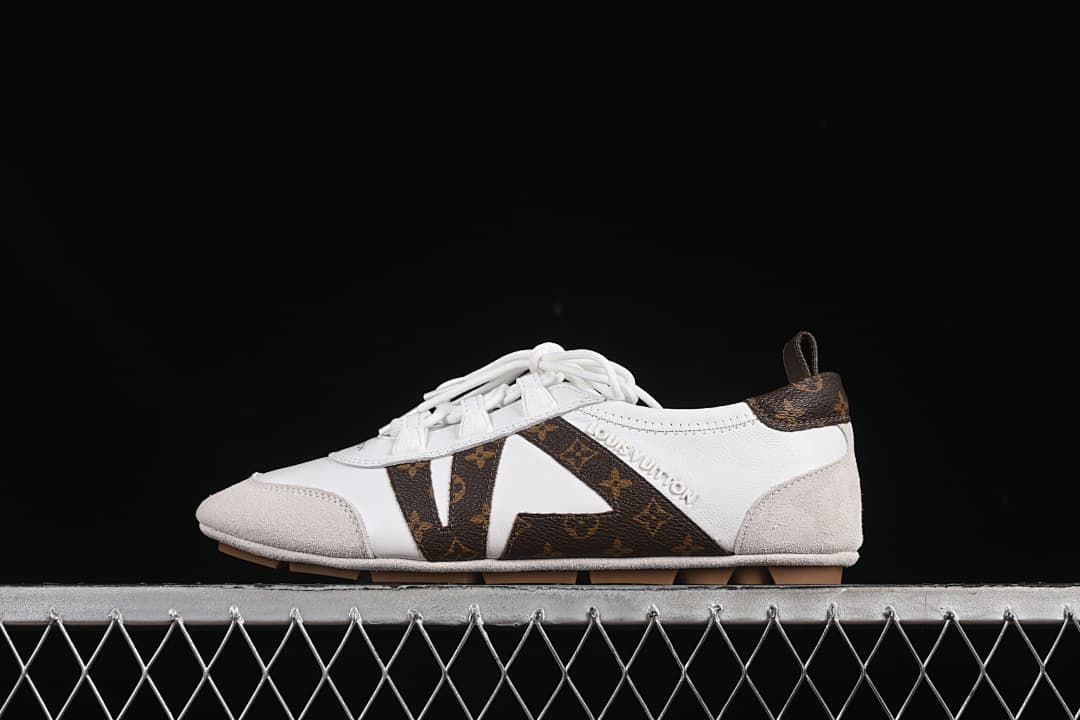 Side view of a white Sneakerina-style lace-up flat with brown patterned accents and light beige overlays.