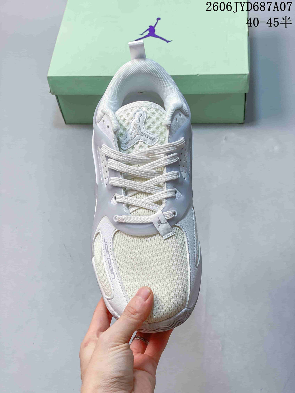Top view of the laces, tongue, and toe on a white Jordan Heir PF shoe.
