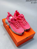 Pair of bright pink Nike Free Metcon 6 shoes on an orange shoe box.