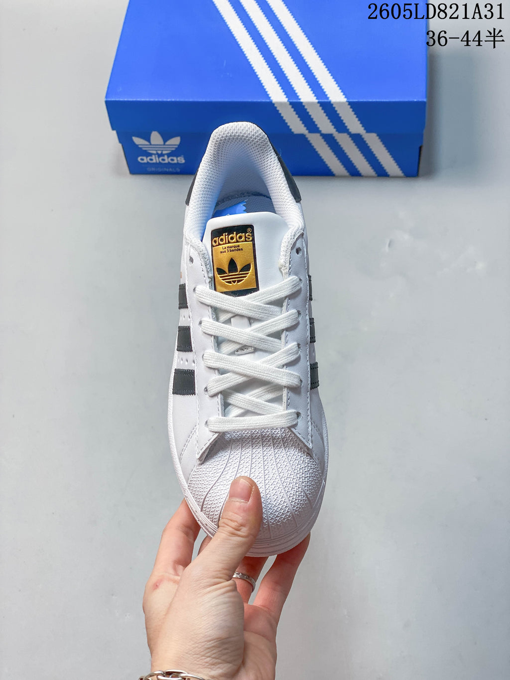 Top view of a white lace-up sneaker with a textured shell toe.