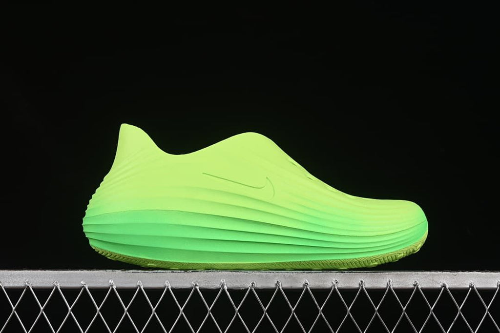 Side profile of the green clog showing its sculpted ridges.