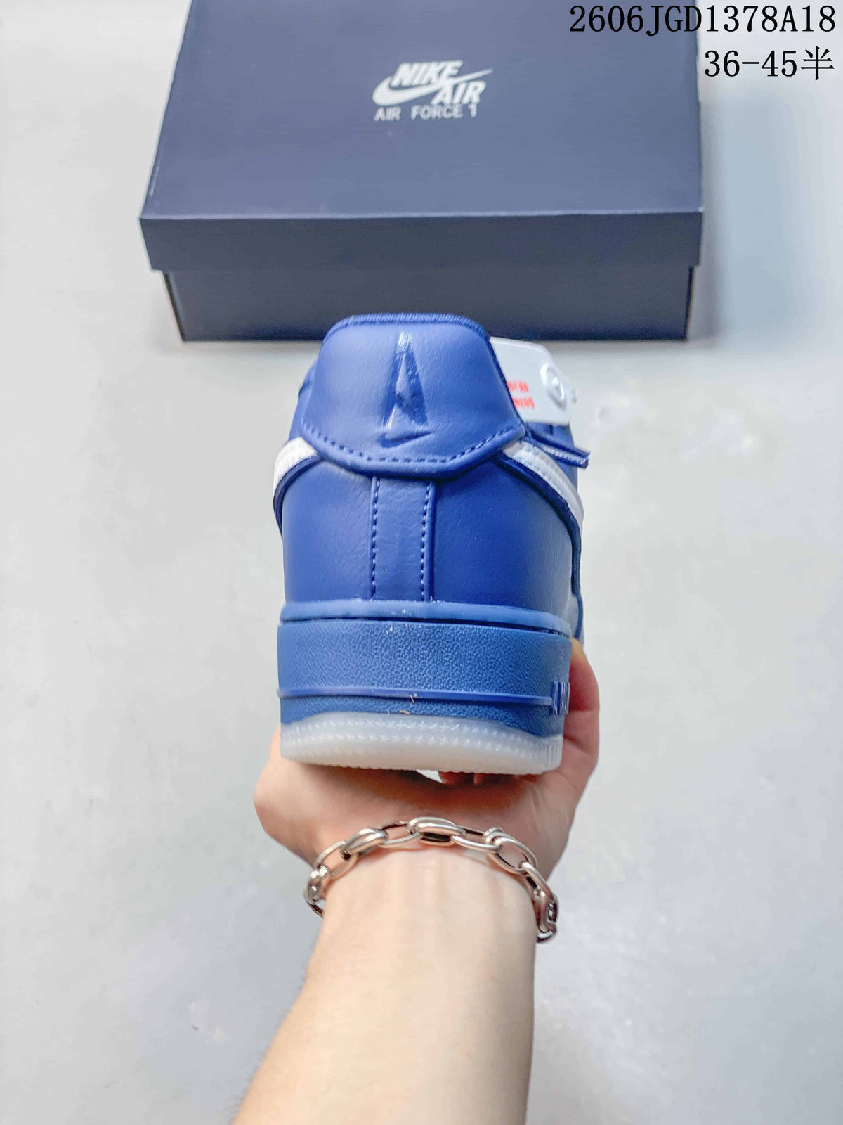 Rear view of a blue sneaker with a white outsole