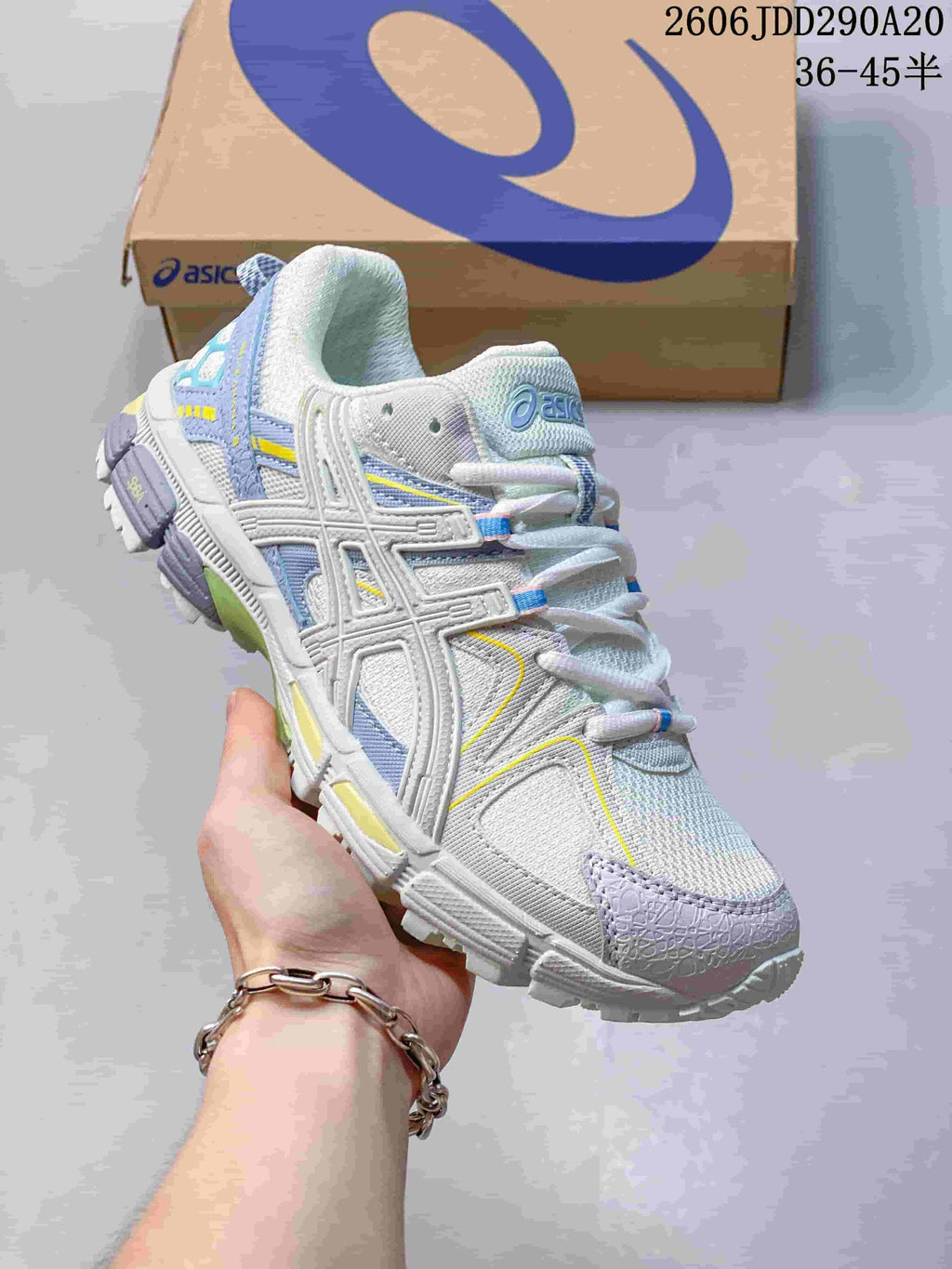 Angled side view of the shoe showing its ASICS side detailing and lavender, blue, and yellow accents.
