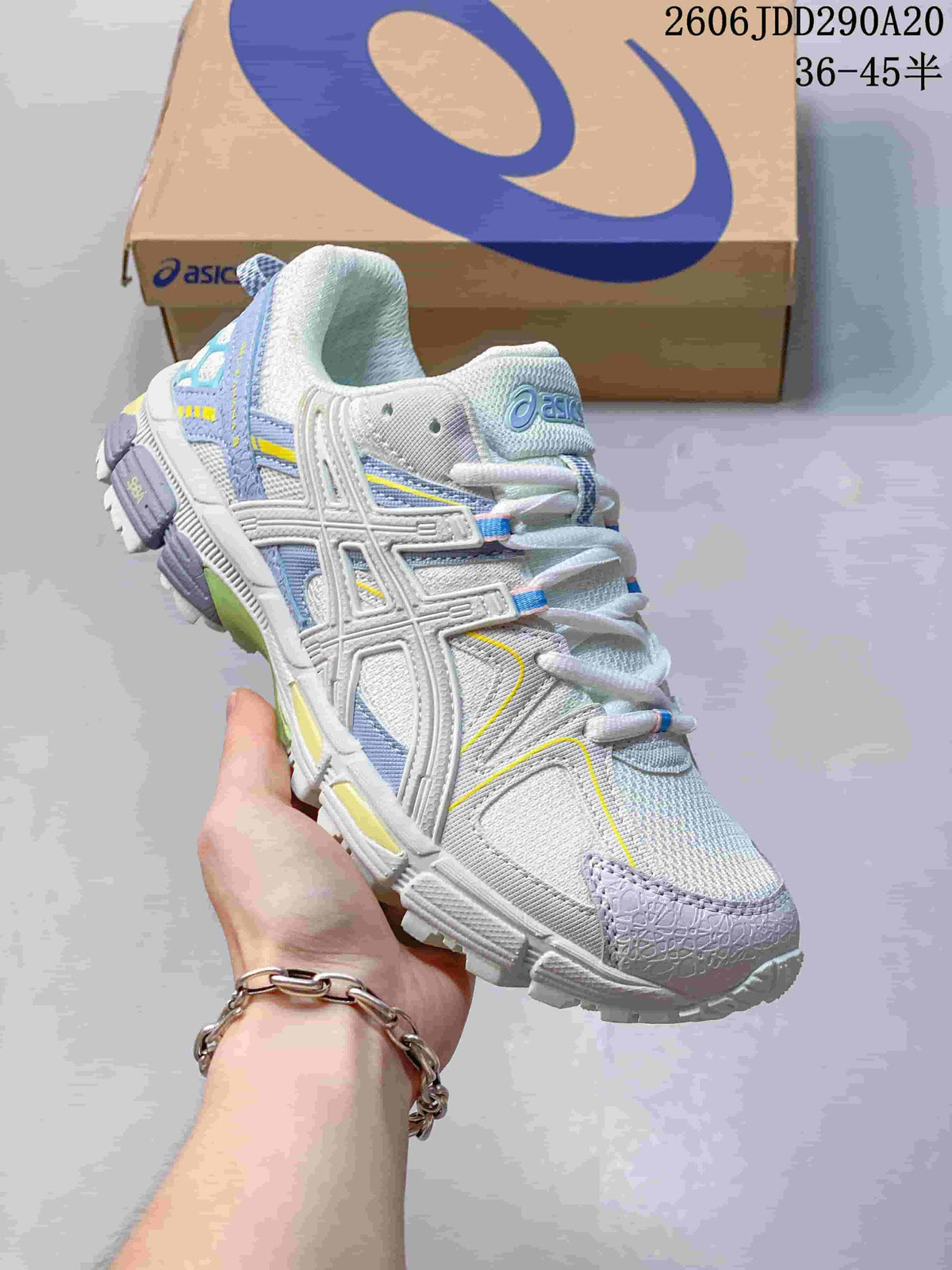 Angled side view of the shoe showing its ASICS side detailing and lavender, blue, and yellow accents.