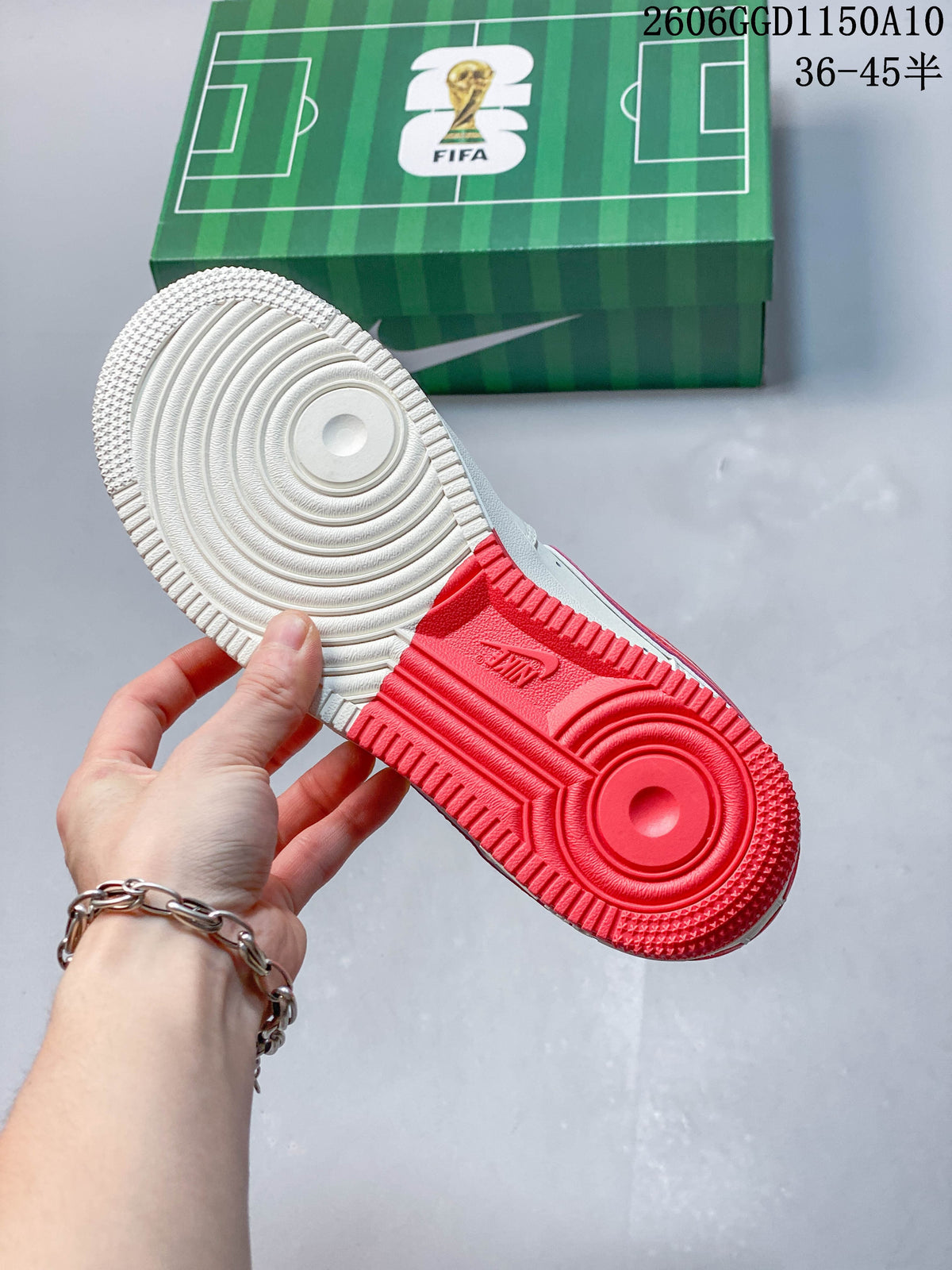 Close-up of the sneaker outsole showing off-white and red sections
