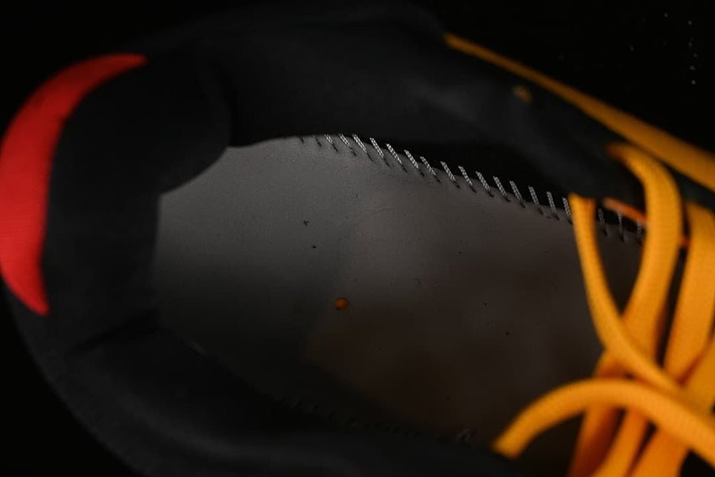 Close-up of the black shoe lining and yellow laces