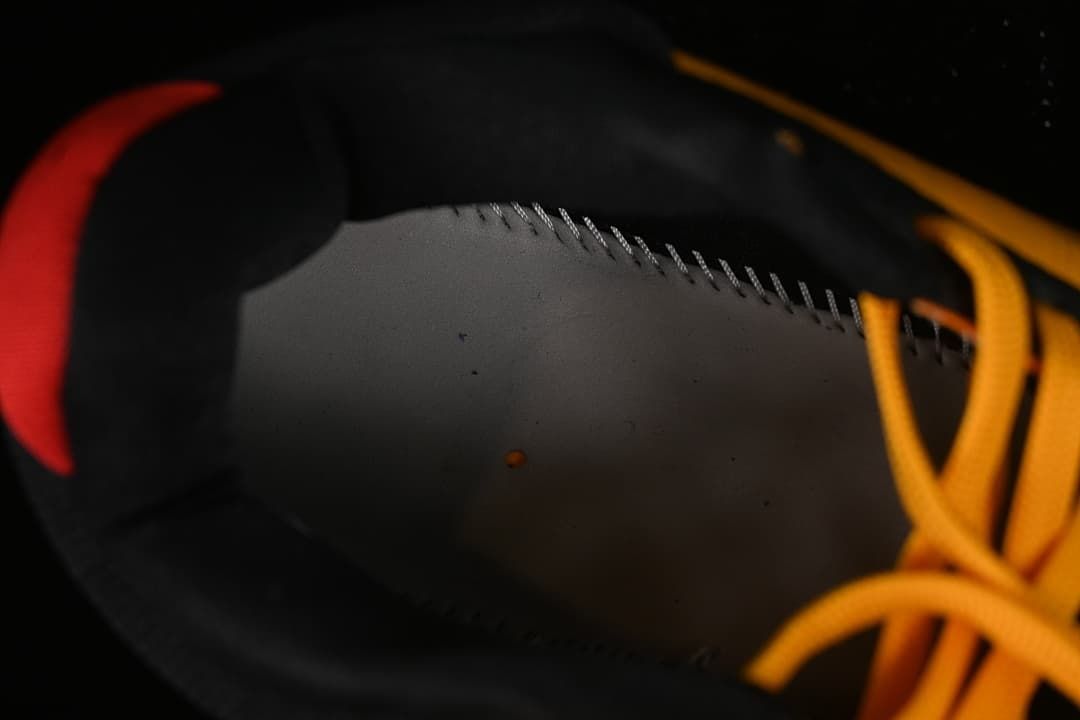 Close-up of the black shoe lining and yellow laces