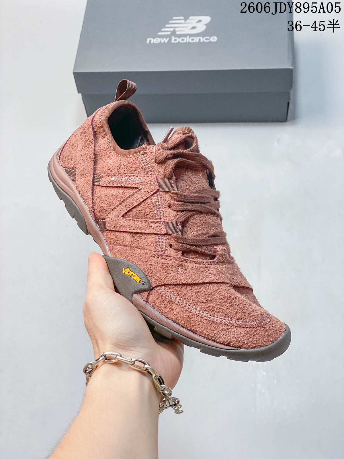 Dusty rose New Balance MT10O low-top sneaker shown from the side