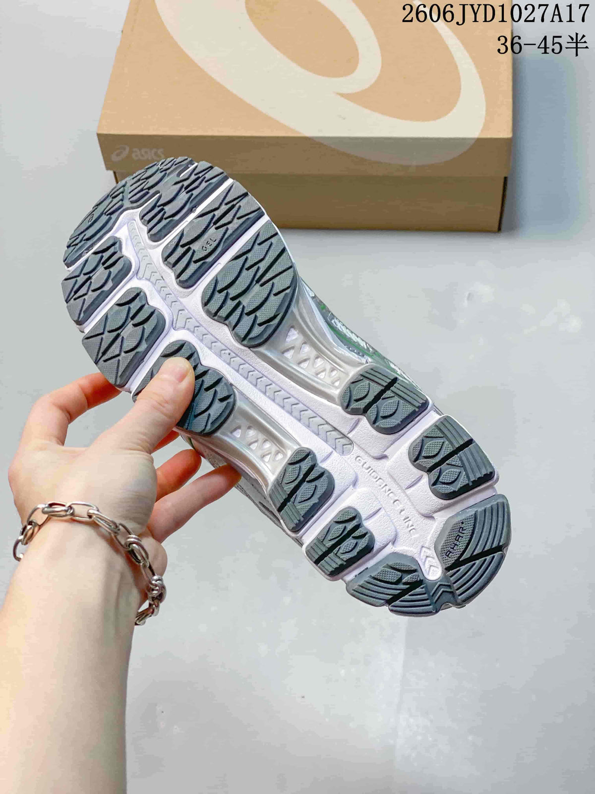 Underside of a sneaker showing a segmented gray and white outsole