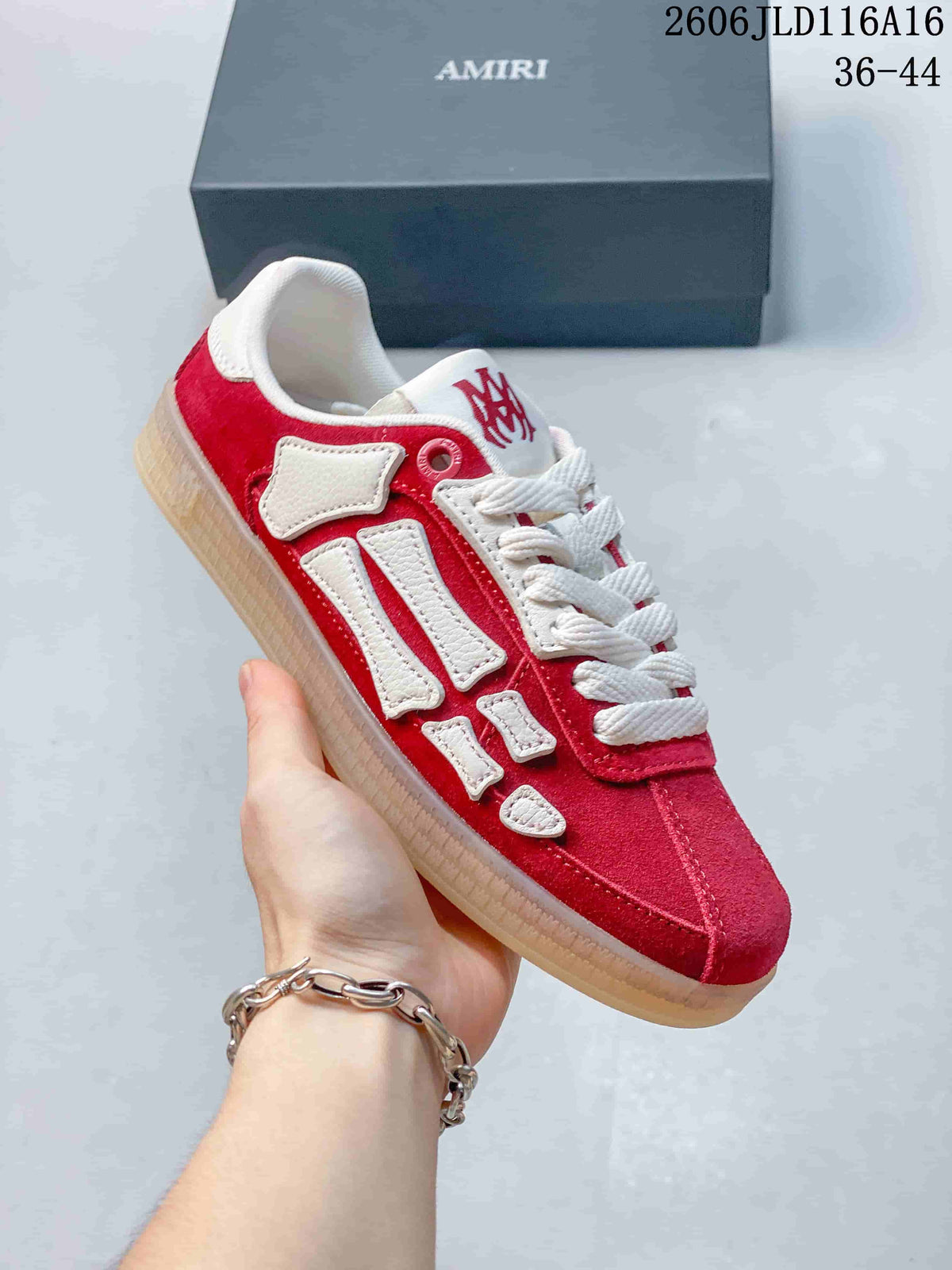 Close angled view of the red upper, white side overlays, and gum-toned sole