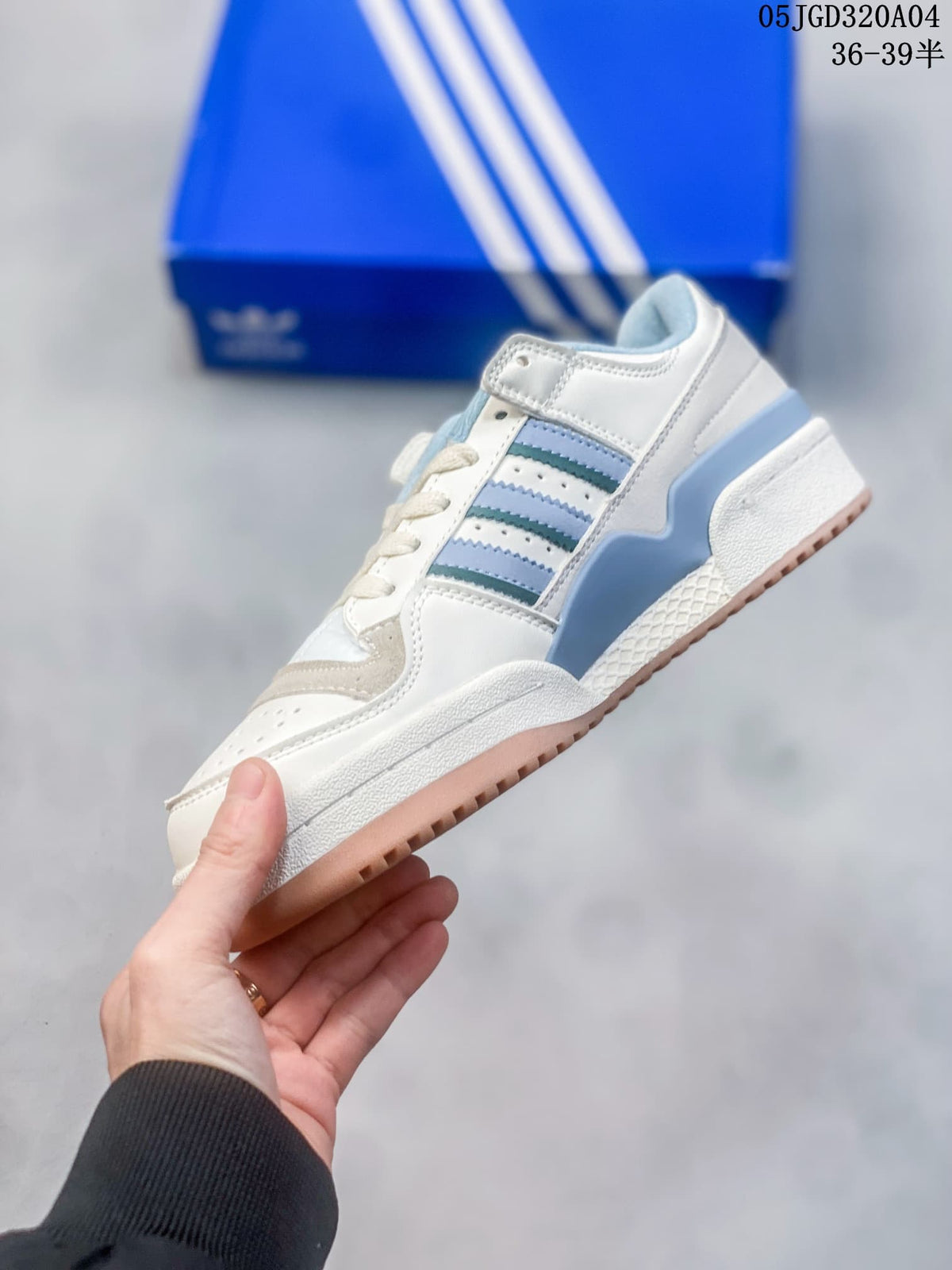 Side view of the white sneaker with blue and teal stripes and an ankle strap