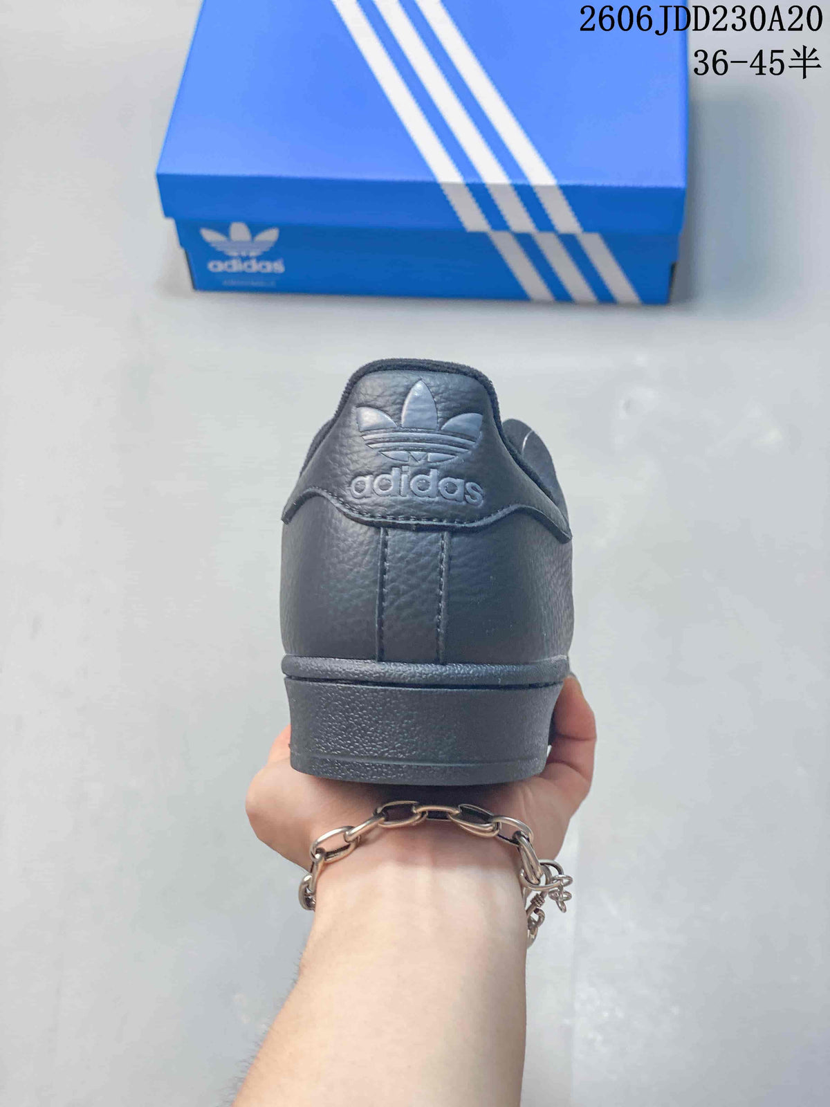 Rear view showing the heel tab and trefoil branding