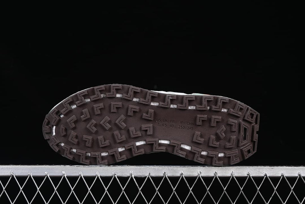 Underside view of the patterned outsole with size markings for the photographed sample