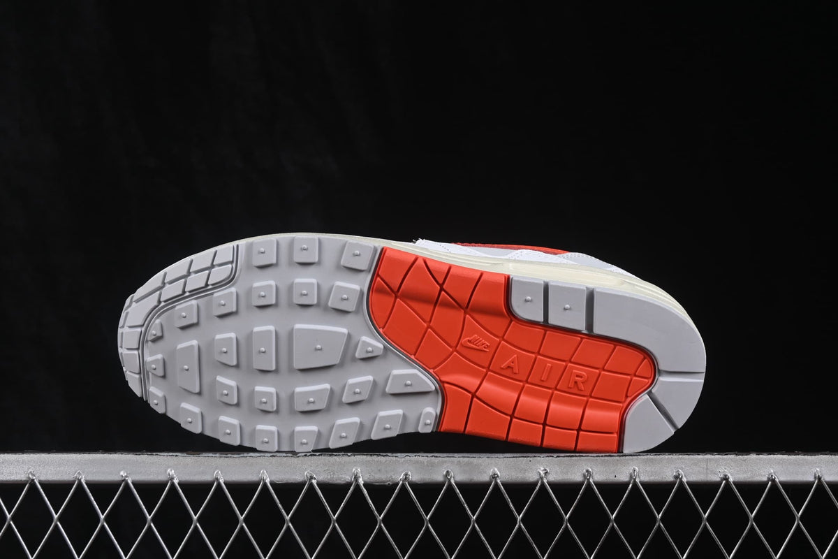 Outsole view showing grey tread sections and a contrasting orange central rubber section with Air branding.