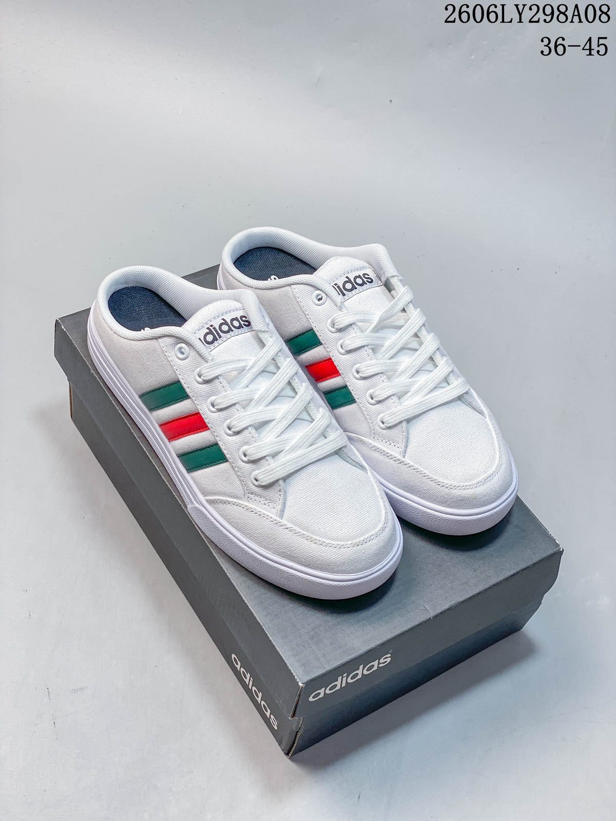 White adidas mule sneakers with green and red side stripes, shown on a shoe box.