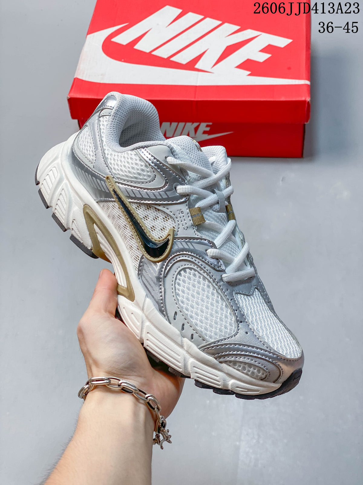 Angled side view of the white and silver running shoe