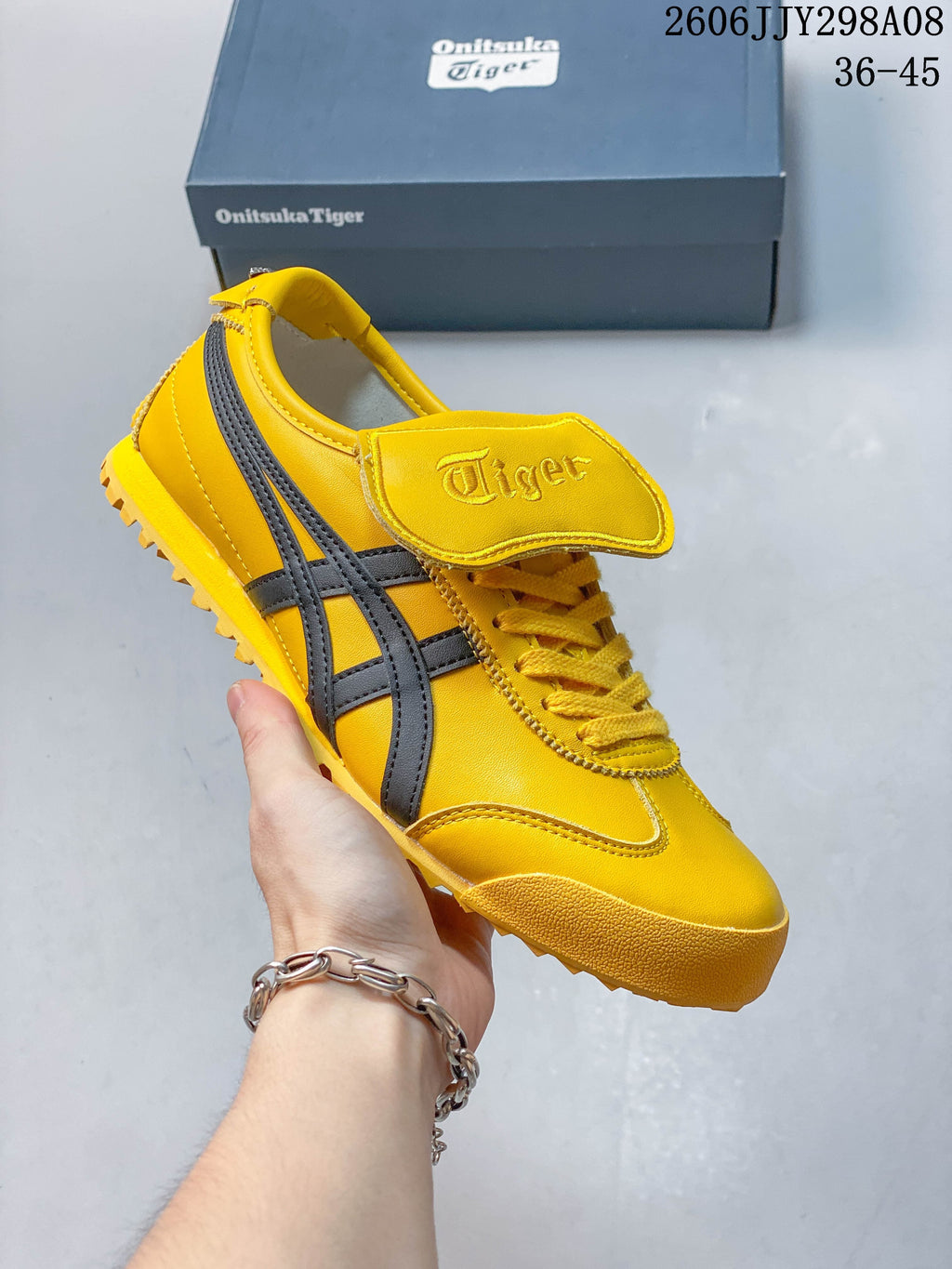 Yellow Onitsuka Tiger Mexico 66 Golf sneaker with dark side stripes and a lugged outsole.