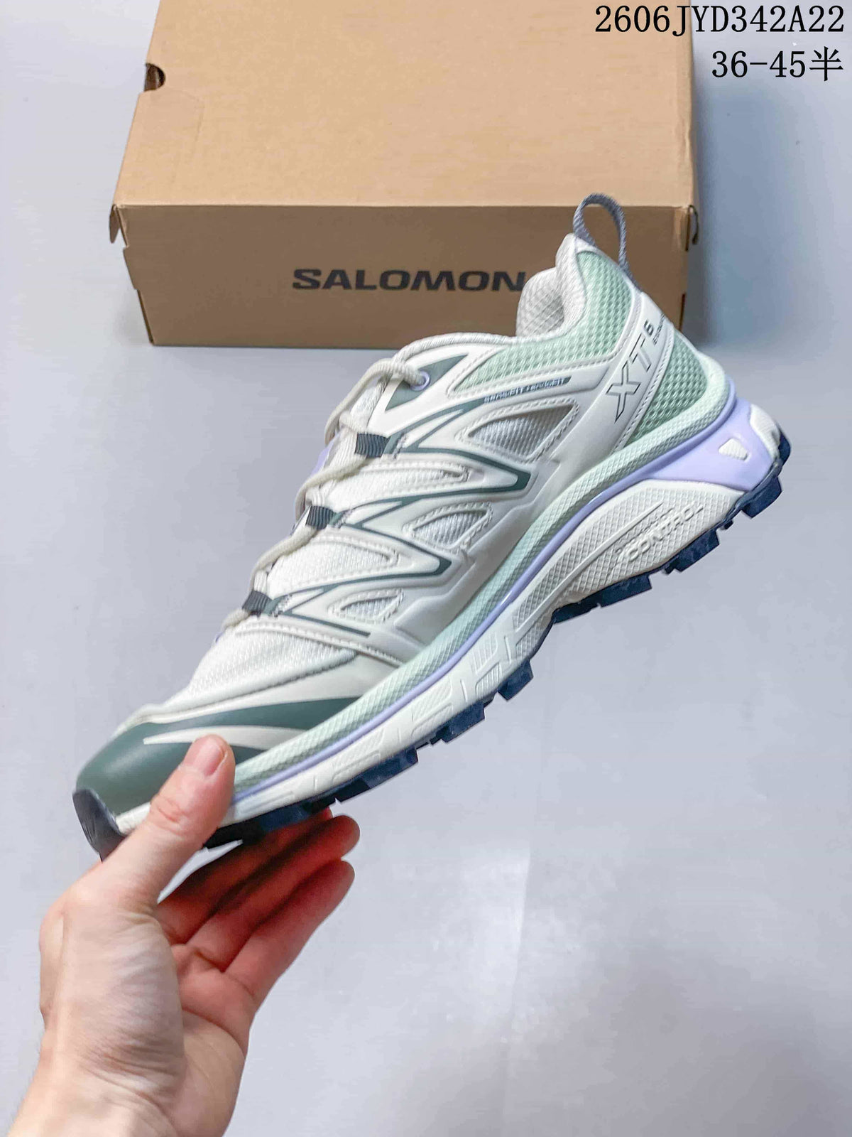 Side view of the sneaker showing the XT-6 marking and layered design