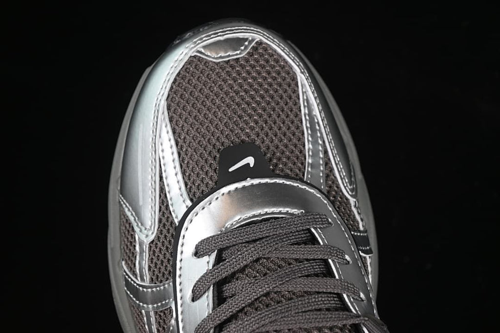 Top-down close-up of the toe, mesh panels, and metallic-look overlays